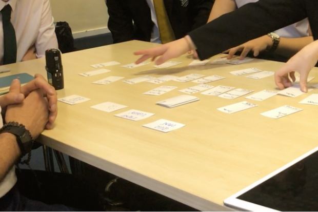 Students playing the card game during a user research session