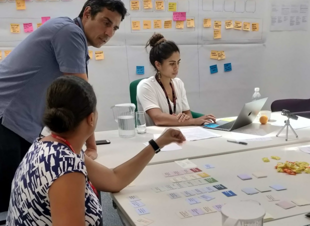 A team undertakes a card sorting exercise with a teacher