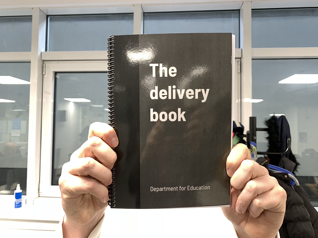 The delivery book being held up