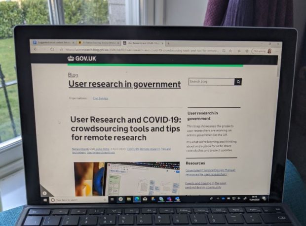 An image of a laptop screen displaying a GDS blog post about 'user research and COVID-19: crowdsourcing tools and tips for remote research'