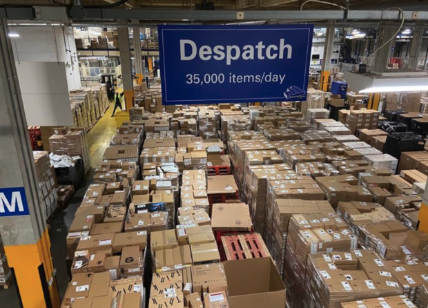 a warehouse full of boxed up computers and laptops